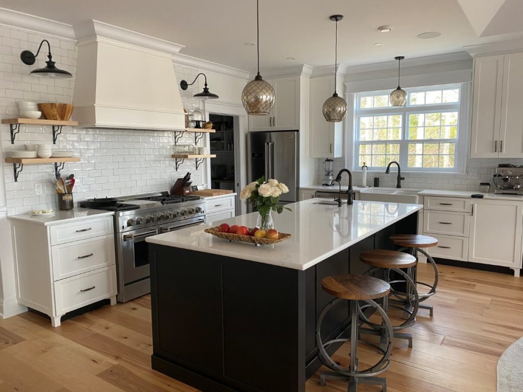 Two tone shaker kitchen with furniture legs and maple floating shelves.