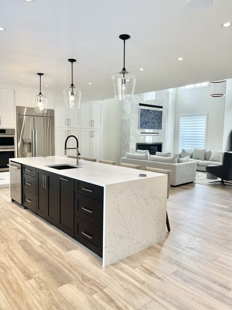 Black shaker island with quartz waterfall countertop