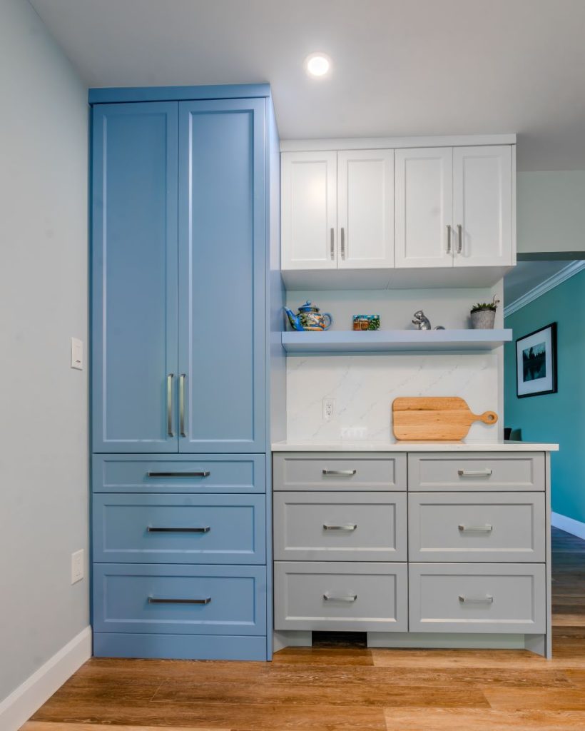 Three tone shaker painted kitchen with floating shelf and lots of storage.