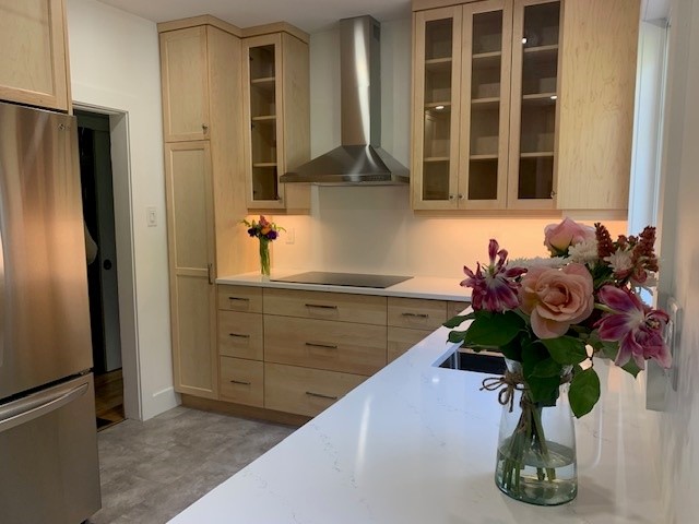 Natural maple kitchen with solid wood shaker doors and quartz countertops.