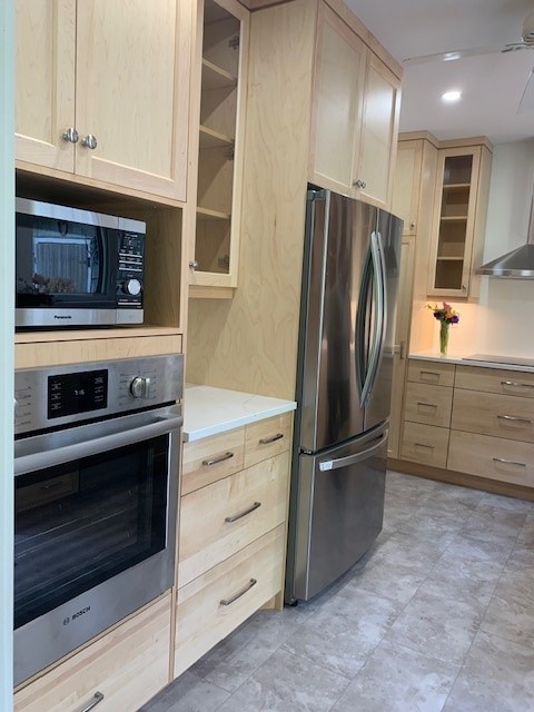 Natural maple kitchen with solid wood shaker doors and quartz countertops.