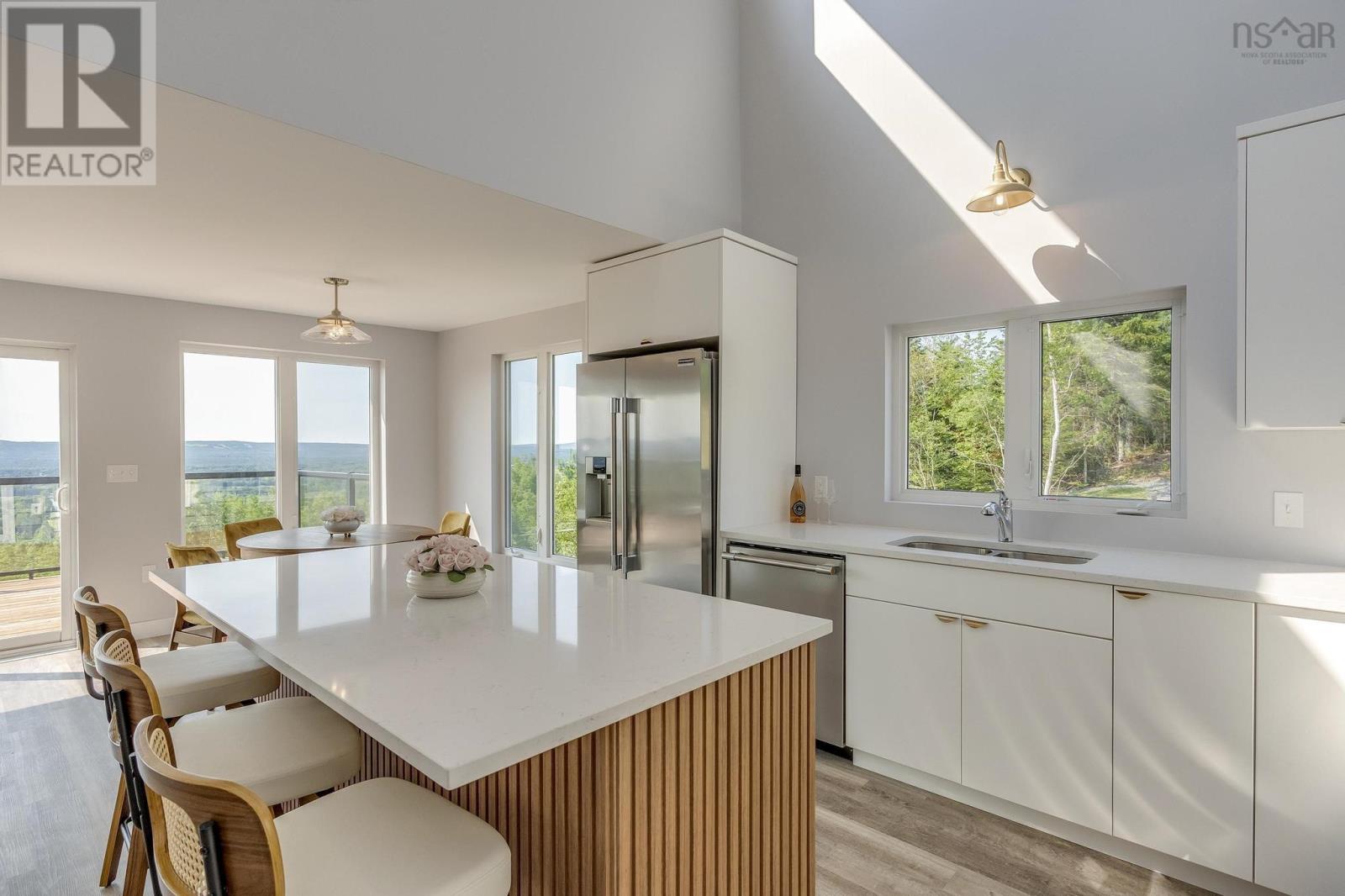 Mid-century modern kitchen in white shaker with champagne bronze hardware