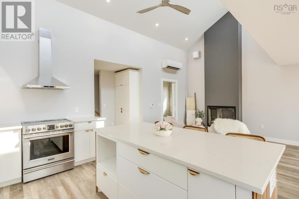 Mid-century modern kitchen in white slab with champagne bronze hardware