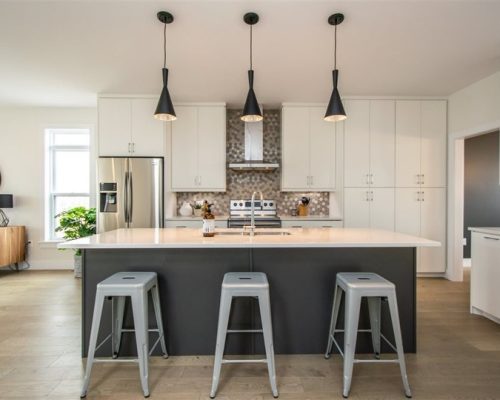 Two tone slab style kitchen with extended seating island.